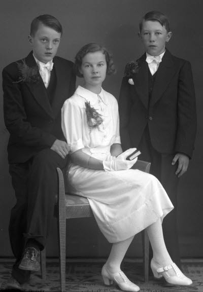 Porträtt av två pojkar och en flicka. Ateljefoto.