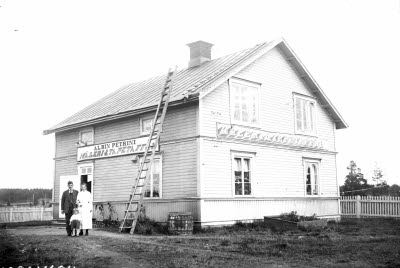 Exteriör med familjen vid förstutrappan.
