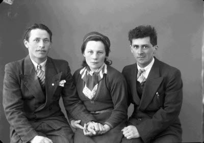 Porträtt av två herrar och en dam. Ateljefoto.