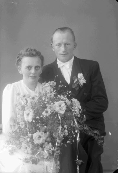 Porträtt av ett brudpar; en herre och en dam. Ateljefoto.