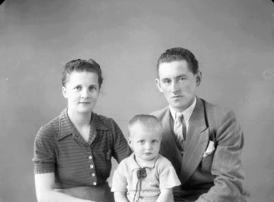 Porträtt av en herre och en dam med ett barn. Ateljefoto.