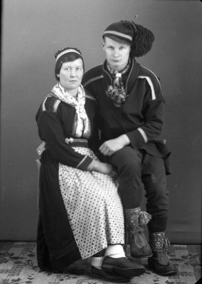 Porträtt av ett par i samedräkter. Ateljefoto.