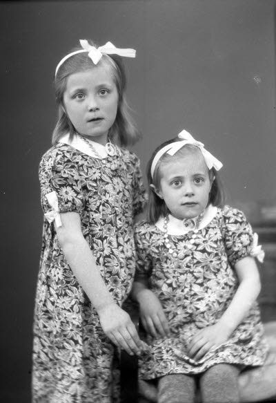 Porträtt av två barn, flickor. Ateljefoto.