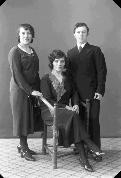 Porträtt av två damer och en herre. Ateljefoto.