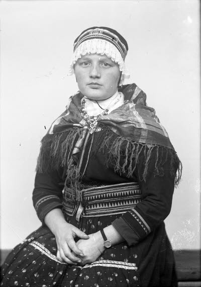 Porträtt av en dam i samedräkt. Ateljefoto.