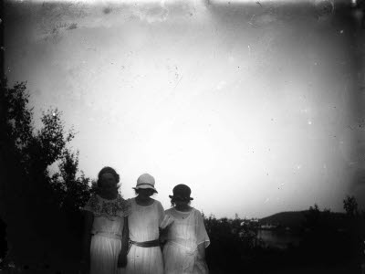 Naturbild: tre damer. Oidentifierade. I bakgrunden skymtar Vassaraträsk och Fjällnäs.