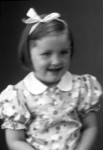 Porträtt av ett barn; en flicka. Ateljefoto.