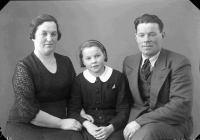 Porträtt av en herre, en dam och ett barn, flicka. Ateljefoto.