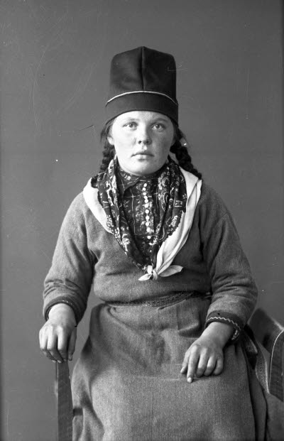 Porträtt av en dam i samedräkt. Ateljefoto.